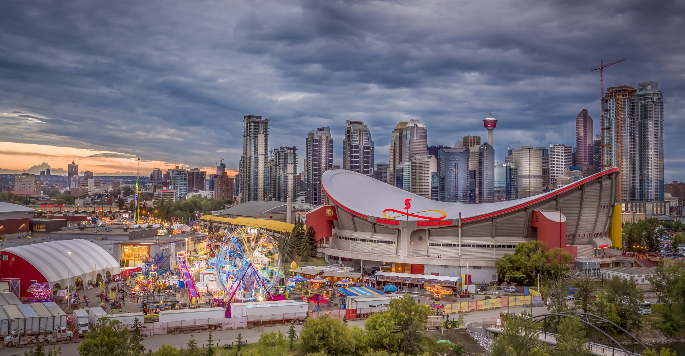 The cityscape of Calgary, Alberta with the Saddledome Arena in the foreground.